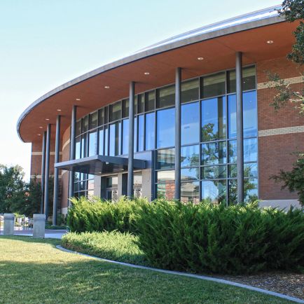 A brick building featuring a distinctive curved roof, showcasing a unique architectural design.