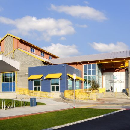 A building facade featuring vibrant yellow and blue awnings, creating a striking visual contrast.