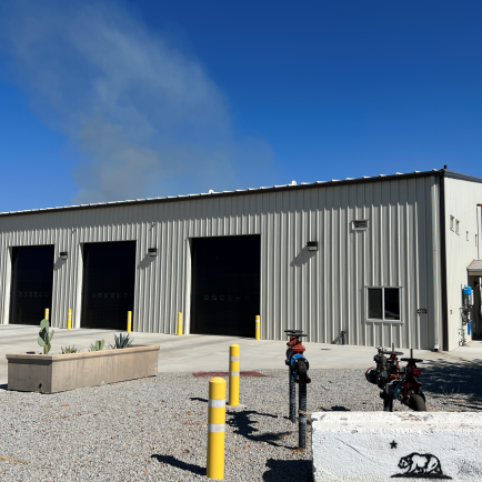 A large building featuring two prominent garage doors, showcasing a functional and spacious design.